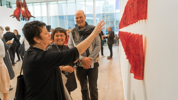 Sonya Kelliher-Coombs and audience in front of her work «Red Curl» at the preview of «Subsistence»